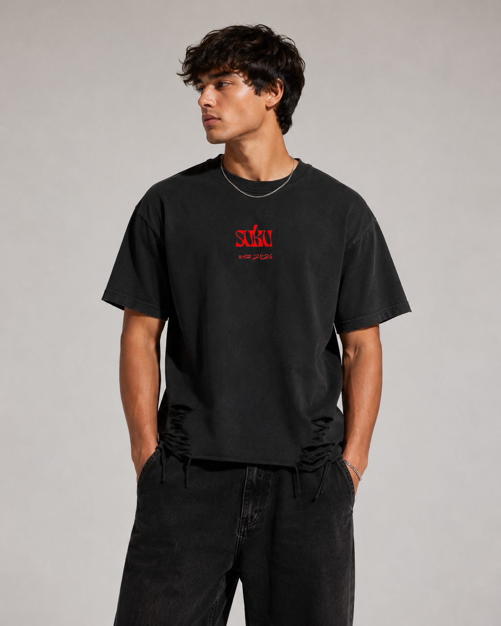 Black Suku Snow Washed Raw-Hem T-Shirt with distressed details, bold red logo on chest, relaxed fit, vintage wash, and raw slits at the hem.