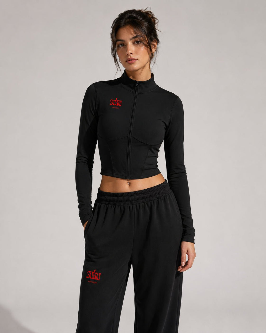 Women’s full-zip sports jacket by Suku featuring a sleek design, lightweight fabric, and a fitted style for activewear.