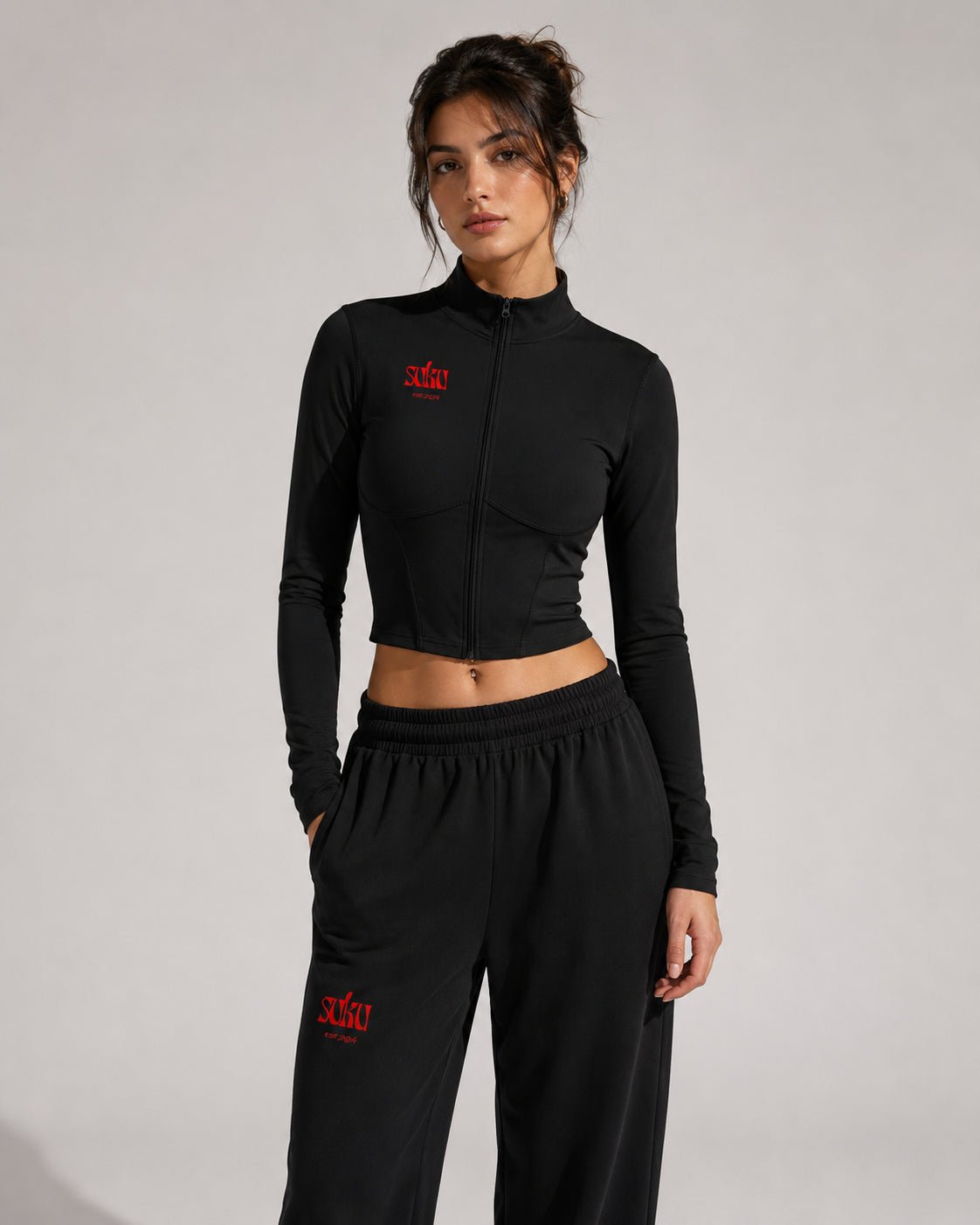 Women’s full-zip sports jacket by Suku featuring a sleek design, lightweight fabric, and a fitted style for activewear.